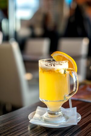 Ginger tea with orange on the table in the cafe,  blurred  background, soft focus.の写真素材
