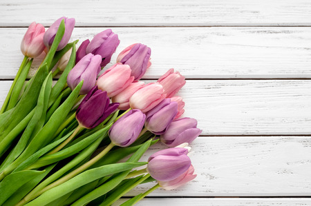 Beautiful multicolored tulips on wooden background. Top view, copy space.の写真素材