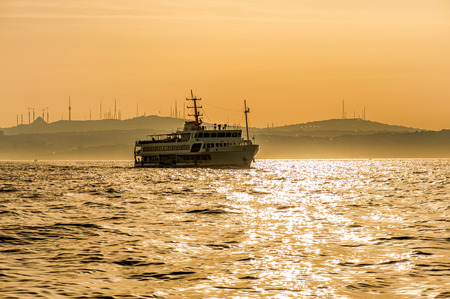 Golden sunset view in the Bosphorus connecting Asian and European continents, Istanbul. The ferries carry passangers to and from the two sides of the city.の写真素材