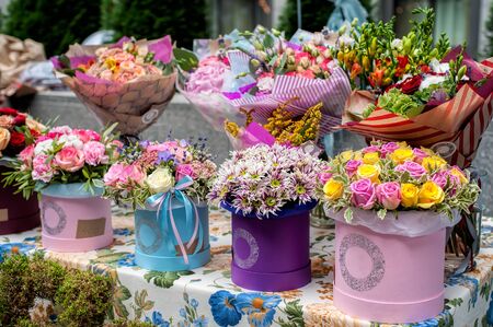 Colorful floral bouquets in box at a flower market. Floral design studio, sale of decorations and arrangements.の写真素材