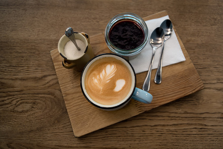 ?appuccino or coffee in blue cup and panna cotta on wooden table background. Concept photo top view, shallow DOF.の写真素材