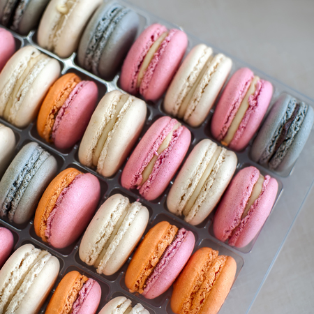 Colorful macarons or macaroons in row, close-up background, selective focus. Square composition.の写真素材