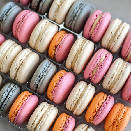 Colorful macarons or macaroons in row, close-up background, selective focus. Square composition.の写真素材