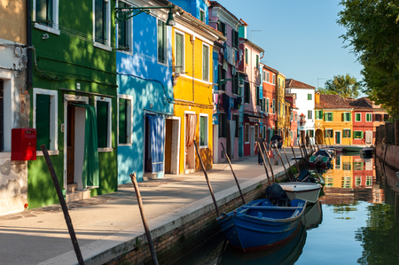 VENICE, ITALY - SEPTEMBER 20, 2012: Canal street with boats and colored houses in Venetian Burano island on 20 of September 2012, Venice, Italy. Burano is an island in the Venetian Lagoonのeditorial素材