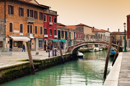 VENICE, ITALY - JANUARY 29, 2011:View of a channel on Murano island which is surrounded with tourist shops selling famous murano glass in Venice, Italy.のeditorial素材