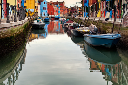 Canal with colorful houses and boats on the famous island Burano, Venice, Italyの写真素材