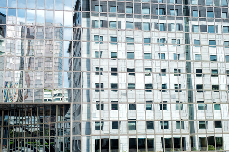Business skyscrapers in reflection. La Defense financial district in Paris, France.Futuristic corporate office buildings. Business abstract background. Mirror facade.のeditorial素材
