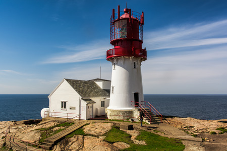 The World famous Lindesnes Fyr Lighthouse on most southern point of Norway staying on the edge of rocky sea coast, , South Norway, Lindesnes Fyr beacon.のeditorial素材