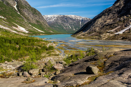 Lake in front of the glacier of Nigardsbreen, in Jostedalsbreen National Park, Norway.の写真素材