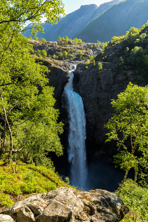 Manafossen waterfall with lush green foliage on foreground in Rogaland, Norway. It is one of the highest waterfalls in Norway. Photo taken in spring.の写真素材