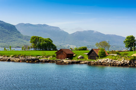 Beautiful Norway natural landscape with two houses, clear water and blue sky, Stavanger, Norway.の写真素材