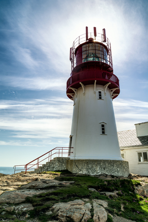 The World famous Lindesnes Fyr Lighthouse on most southern point of Norway staying on the edge of rocky sea coast, , South Norway, Lindesnes Fyr beacon.の写真素材