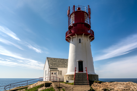 The World famous Lindesnes Fyr Lighthouse on most southern point of Norway staying on the edge of rocky sea coast, , South Norway, Lindesnes Fyr beacon.のeditorial素材