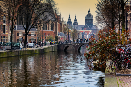 Amsterdam canal with typical dutch houses, Holland, Netherlands. St. Nicholas Church in Amsterdam.のeditorial素材