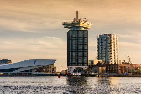 AMSTERDAM, NETHERLANDS - APRIL 13, 2018: The Aâdam Tower - a high building in Amsterdam with swing standing, and Eye Film Museum at dawn.のeditorial素材