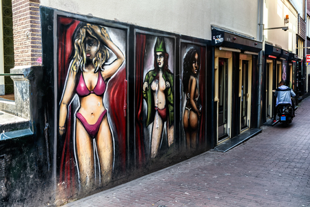AMSTERDAM, NETHERLANDS - APRIL 11, 2018: Graffiti in the Amsterdam red light district. De Wallen is the largest and best-known red-light district in Amsterdam and a major tourist attraction.の写真素材