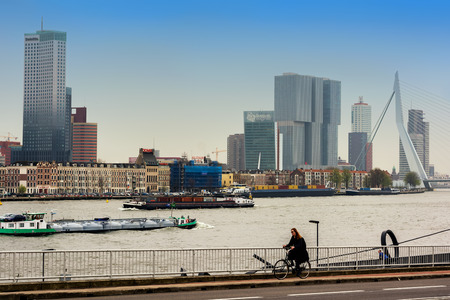 ROTTERDAM, NETHERLANDS - APRIL 13, 2018: Rotterdam embankment with 'De Rotterdam' skyscraper and Erasmus bridge viewed from across the river Nieuwe Maas.のeditorial素材