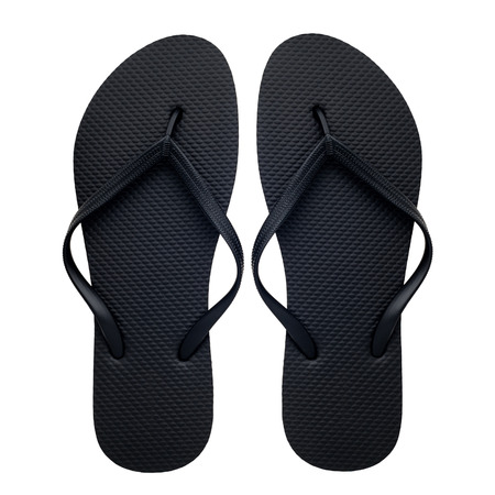 Black rubber flip-flops isolated over white background, pair of thongs, shot above.の写真素材