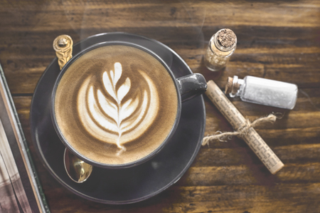 cup of coffee with latte art on vintage wooden tableの写真素材