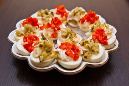 eggs with cucmber and red pepper with mayonnaise on the plateの写真素材