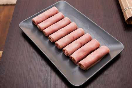 stuffing hams roll on the gray plateの写真素材