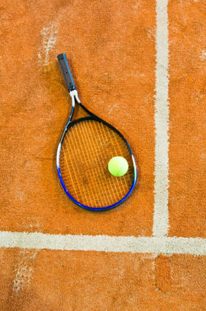 tennis racket on the court and ball