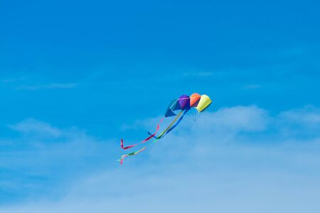 colourful kite with ribbon flying in the airの写真素材