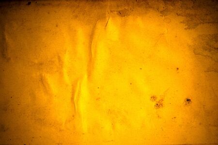 old yellow paper background with scratches の写真素材