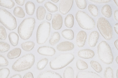 textured stone wall background with small stones and cement の写真素材