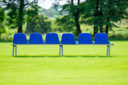 blue plastic bench on green grassの写真素材