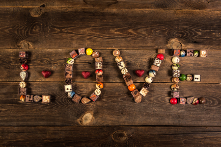 LOVE word arranged with pralines on the wooden plank backgroundの写真素材