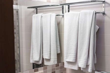 two white towels on the hangerの写真素材