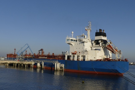 Blue products tanker in operations at the Oil Terminal of Lorient, France. Horizontal view from sternの写真素材