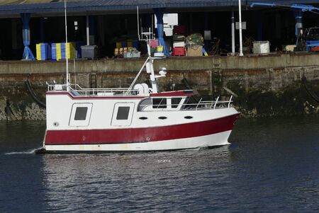 Coastal fishing boat Underway in the harbor.の写真素材