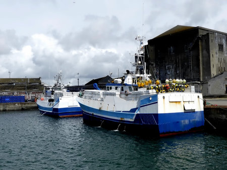 Fishing boats docked at Keroman wharf, Lorient, Brittany, France. Horizontal stern view