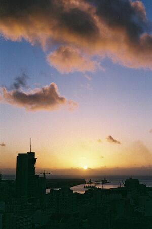 View of a city at sunset from a hillの写真素材