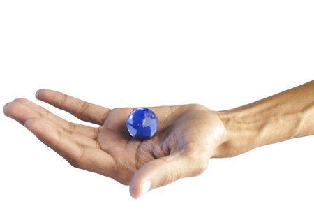 Conceptual image of a hand holding a world symbolizing controlの写真素材