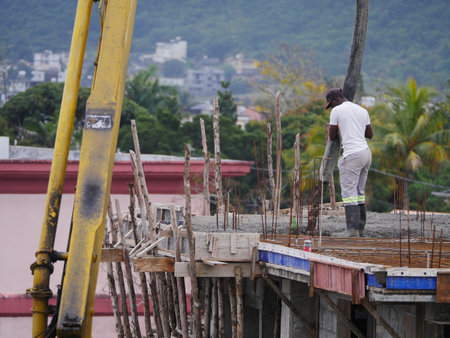 Pouring cement on roof of building in construction