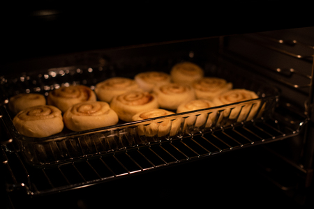homemade cinnamon rolls, baking in the owenの写真素材