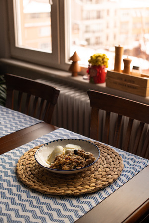 baked oatmeal with banana, blueberries, walnut and raisins. served with yoghurt and honeyの写真素材