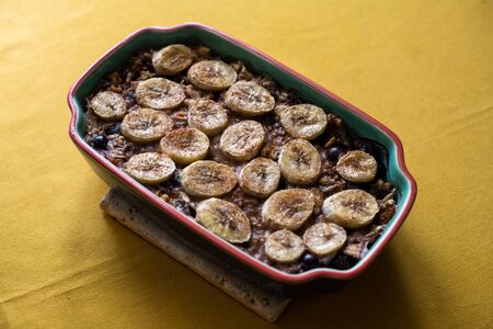 Baked oatmeal with bananas, blueberries, and walnuts. served in stonewareの写真素材