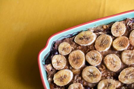 Baked oatmeal with bananas, blueberries, and walnuts. served in stonewareの写真素材