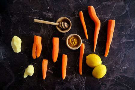 Vitamin boost, carrots, ginger, lemon, golden milk. Mixture of healthy fruits and vegetables. Immunity boost.の写真素材