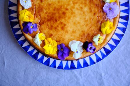 San Sebastian Cheesecake, decorated with edible flowersの写真素材