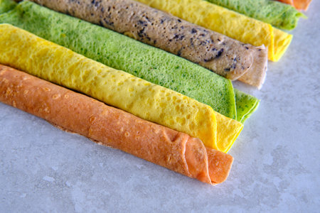 Pancakes of different color. Spinach, beetroot powder, blueberry and turmeric crepes.