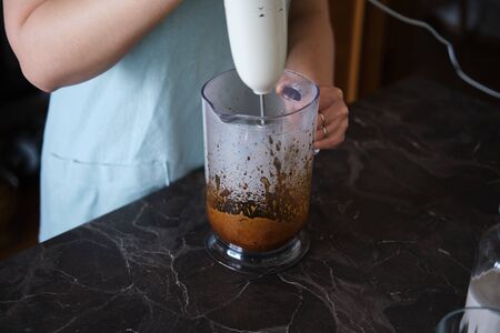 Making Dalgona Coffee at home, Preparing Homemade Dalgona Coffeeの写真素材