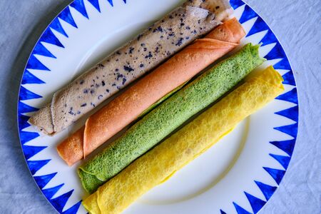 Pancakes of different color. Spinach, beetroot powder, blueberry and turmeric crepes.の写真素材