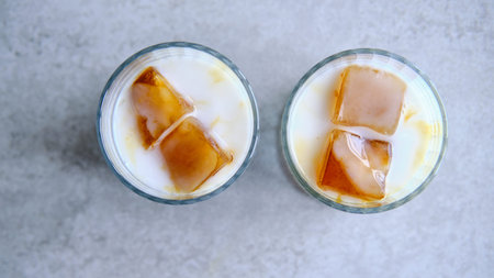 Ice cubes made with coffee in glass, preparing refreshing coffee drink