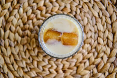 Ice cubes made with coffee in glass, preparing refreshing coffee drinkの写真素材