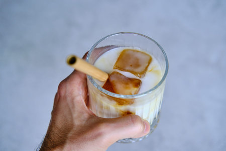 Ice cubes made with coffee in glass, preparing refreshing coffee drink